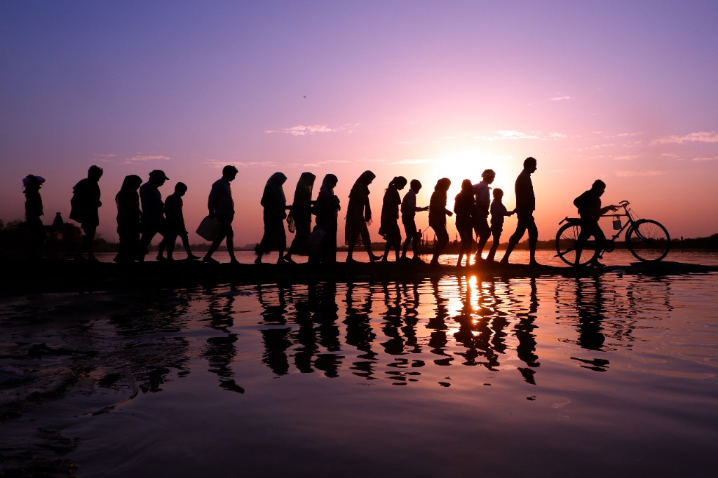 Sunset silhouettes along the sacred river bank