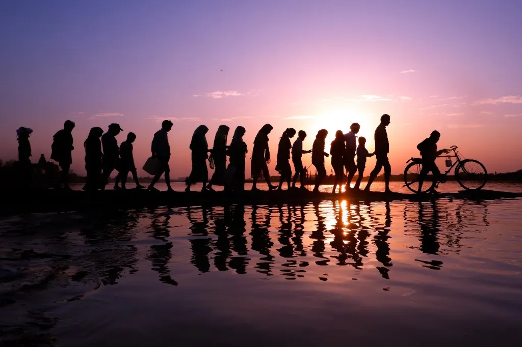 Sunset silhouettes along the sacred river bank